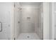 Large walk-in shower with bench seat and neutral tile at 2735 Marie Way, Cumming, GA 30028