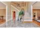 Elegant two-story entryway with marble flooring and grand staircase at 440 Dix Lee On Dr, Fayetteville, GA 30214