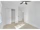 A well lit bedroom with a ceiling fan and a closet with open doors at 2067 Arlington Nw Cir, Atlanta, GA 30318