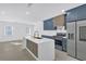 A kitchen features navy cabinets with gold hardware, white countertops, and stainless steel appliances at 2067 Arlington Nw Cir, Atlanta, GA 30318