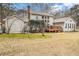 Spacious backyard featuring a wooden deck, grassy lawn, and home exterior with many windows at 112 Christopher Ln, Stockbridge, GA 30281