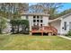 Backyard featuring a deck, grassy lawn, and the back of the home with plenty of windows at 112 Christopher Ln, Stockbridge, GA 30281