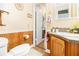 Compact bathroom featuring wood paneling and traditional fixtures at 112 Christopher Ln, Stockbridge, GA 30281