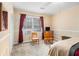 Bedroom featuring carpet flooring, vintage wood furniture, and a window with a view of nature at 112 Christopher Ln, Stockbridge, GA 30281