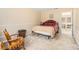 Bedroom with carpet flooring, rocking chair, and a queen-size bed with patterned bedding at 112 Christopher Ln, Stockbridge, GA 30281