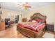 Bedroom showcasing wood floors, ceiling fan, and a large wooden bed with red and white patterned bedding at 112 Christopher Ln, Stockbridge, GA 30281