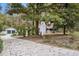 Long driveway leads to a traditional home with a two-car garage and mature trees at 112 Christopher Ln, Stockbridge, GA 30281