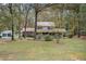 Traditional home with a covered front porch, two-car garage, and mature trees at 112 Christopher Ln, Stockbridge, GA 30281