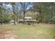 Traditional two-story home with manicured lawn, mature trees, and a two-car garage at 112 Christopher Ln, Stockbridge, GA 30281