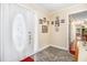 Elegant foyer with marble-patterned flooring, decorative front door, and adjacent hallway at 112 Christopher Ln, Stockbridge, GA 30281