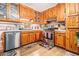 Functional kitchen featuring stainless steel appliances and ample wood cabinets at 112 Christopher Ln, Stockbridge, GA 30281