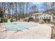 Backyard pool with winter safety cover, black fence, and home in the background at 112 Christopher Ln, Stockbridge, GA 30281