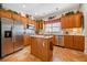 Spacious kitchen with island, stainless steel appliances, and wood cabinets at 7420 Colony Ct, Cumming, GA 30041