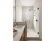 Elegant bathroom featuring glass shower with bronze hardware and marble countertop at 1188 Lupo Loop, Chattahoochee Hills, GA 30268