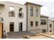 A modern home featuring a brick facade with black framed windows and balcony for a luxurious urban feel at 1188 Lupo Loop, Chattahoochee Hills, GA 30268