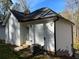 White vinyl sided home with a black roof and gutters at 3385 Continental Dr, Cumming, GA 30041