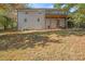 Exterior view of a white brick home and spacious, grassy backyard at 490 E Pharr Rd, Decatur, GA 30030