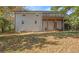 Exterior view of a white brick home and spacious, grassy backyard at 490 E Pharr Rd, Decatur, GA 30030