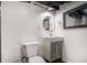 Modern powder room featuring a square sink, mirrored cabinet, and toilet at 490 E Pharr Rd, Decatur, GA 30030