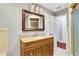 Bathroom boasts granite vanity, tiled floor, and an updated mirror at 1852 Red Rose Ln, Loganville, GA 30052