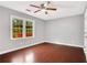 Bright bedroom with hardwood floors and ceiling fan at 1852 Red Rose Ln, Loganville, GA 30052