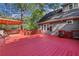 Large red deck perfect for outdoor entertaining, with a pergola and wooded views at 1852 Red Rose Ln, Loganville, GA 30052