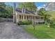 Charming craftsman style home with gray siding, a covered porch, and landscaped lawn at 1852 Red Rose Ln, Loganville, GA 30052