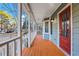 Inviting front porch with white railings and a red front door at 1852 Red Rose Ln, Loganville, GA 30052