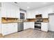 Bright kitchen with white cabinets, granite countertops, and stainless steel appliances at 1852 Red Rose Ln, Loganville, GA 30052