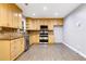 Modern kitchen with light wood cabinets, granite counters, and stainless steel appliances at 1852 Red Rose Ln, Loganville, GA 30052