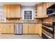 Modern kitchen with light wood cabinets, granite counters, and stainless steel appliances at 1852 Red Rose Ln, Loganville, GA 30052