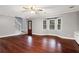 Spacious living room featuring hardwood floors, bay window, and a ceiling fan at 1852 Red Rose Ln, Loganville, GA 30052