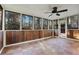 Sunroom with terracotta tile floors, wood walls and ceiling fan at 1852 Red Rose Ln, Loganville, GA 30052