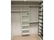 White closet with shelves and hanging rods at 775 Juniper Ne St # 614, Atlanta, GA 30308