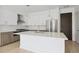 Well-lit kitchen featuring a large island, stainless steel refrigerator, and modern fixtures at 775 Juniper Ne St # 614, Atlanta, GA 30308