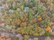 Beautiful lot featuring trees in fall color, showcasing the privacy of the surrounding landscape at 220 Spring Branch Dr, Canton, GA 30115