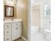 Well-lit bathroom featuring a tiled shower/tub combo and white cabinets, providing a clean and functional space at 220 Spring Branch Dr, Canton, GA 30115