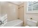 Clean bathroom featuring a tiled shower/tub combo and plantation shutters at 220 Spring Branch Dr, Canton, GA 30115