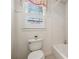 Bright bathroom featuring a white toilet, white subway tile shower, and a window with patterned curtains at 220 Spring Branch Dr, Canton, GA 30115