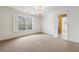 Bright bedroom with a window that has plantation shutters, plush carpeting, and an en-suite bathroom at 220 Spring Branch Dr, Canton, GA 30115