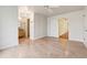 Light-filled bedroom with hardwood floors, adjacent bathroom, and a hall that lead to other rooms at 220 Spring Branch Dr, Canton, GA 30115