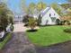 Well-maintained home featuring a spacious lawn and extended driveway to the garage at 220 Spring Branch Dr, Canton, GA 30115