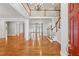 Bright foyer with hardwood floors, a staircase, and a view of the second-floor balcony at 220 Spring Branch Dr, Canton, GA 30115