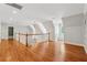 Elegant hallway with hardwood floors, chandelier, and a charming window seat provides a bright and inviting atmosphere at 220 Spring Branch Dr, Canton, GA 30115