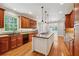 Gourmet kitchen featuring custom cabinetry, a center island, granite countertops, and modern appliances at 220 Spring Branch Dr, Canton, GA 30115