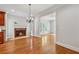 Bright living room features a fireplace, chandelier, hardwood floors and an open entryway to another room at 220 Spring Branch Dr, Canton, GA 30115