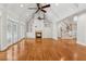Open living area features hardwood floors, fireplace, built-ins, vaulted ceilings, and staircase at 220 Spring Branch Dr, Canton, GA 30115