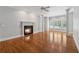 Bright living room with hardwood floors, fireplace, large windows, and columns adding architectural interest at 220 Spring Branch Dr, Canton, GA 30115
