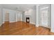 Spacious living room features hardwood floors, a fireplace, and access to the outside through a shuttered door at 220 Spring Branch Dr, Canton, GA 30115