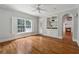 Well-lit living room with a built-in bookcase and entertainment center, a large window, and hardwood floors at 220 Spring Branch Dr, Canton, GA 30115